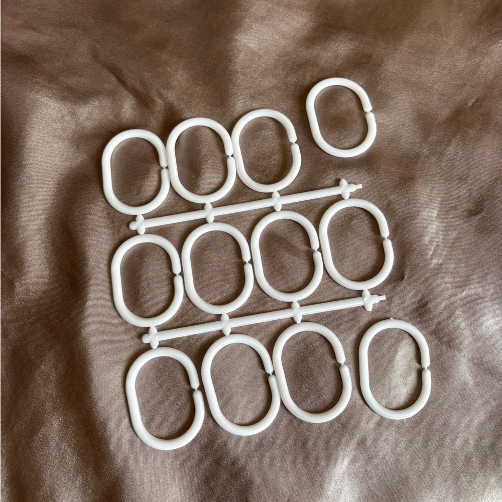 White plastic shower curtain rings